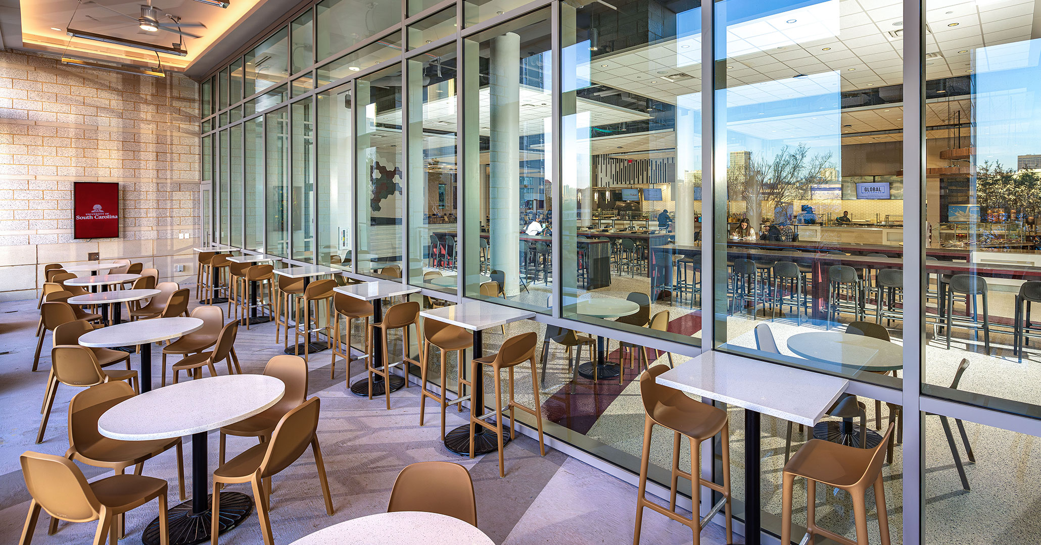 Outside seating options for the Pavilion dining hall at USC’s Campus Village designed by BOUDREAUX