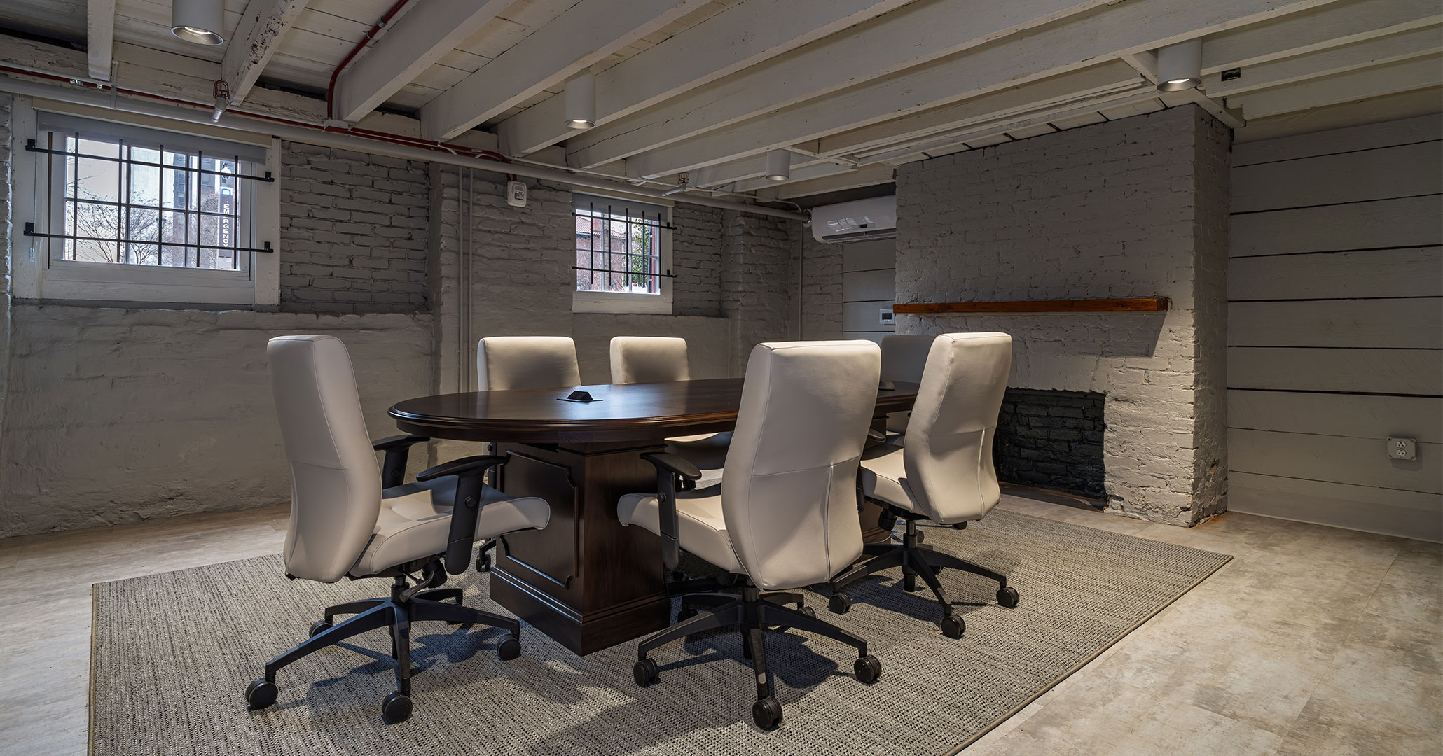BOUDREAUX architects used the existing basement to create a private meeting room with natural light